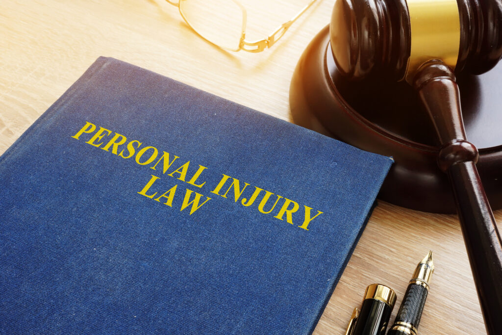 Personal injury law book on a desk and gavel.