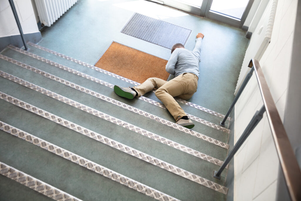 Photo of a Man Lying On Staircase After Slip And Fall Accident